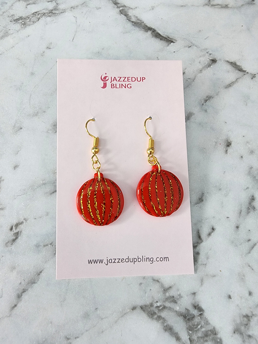 Handmade polymer clay Christmas bauble earrings in red with gold glitter
