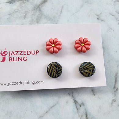 Coral flower and black-gold geometric polymer clay stud earrings from Jazzed Up Bling, handmade in New Zealand.