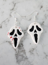 Load image into Gallery viewer, Handmade mismatched Ghost Face Halloween earrings – one blood splatter and one plain – horror polymer clay jewelry NZ.
