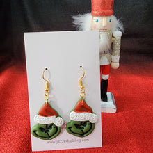 Load image into Gallery viewer, Handmade Grinch Christmas earrings with green face and Santa hat – fun holiday jewelry.
