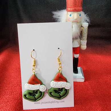 Handmade Grinch Christmas earrings with green face and Santa hat – fun holiday jewelry.
