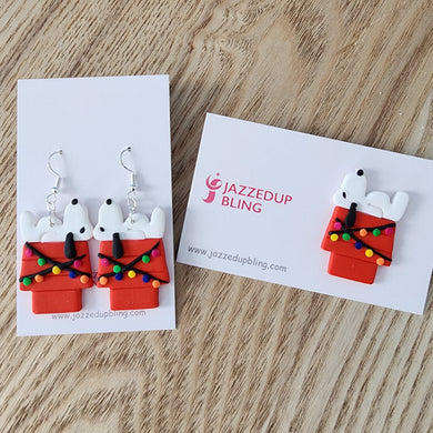 Handmade Joe Cool Christmas earrings and brooch featuring Joe Cool on a decorated red doghouse with festive lights – Jazzed Up Bling NZ.