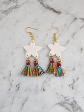 Load image into Gallery viewer, Handmade white star lantern parol earrings with colorful tassels and gold hooks, inspired by Filipino Christmas lanterns.
