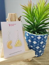 Load image into Gallery viewer, Mismatched handmade polymer clay earrings shaped like macaroni and cheese wedge on display – Jazzed Up Bling.
