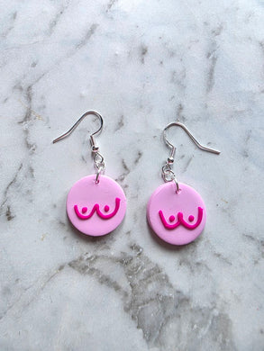 Handmade pink awareness earrings made from polymer clay with stainless hooks, supporting breast cancer awareness.