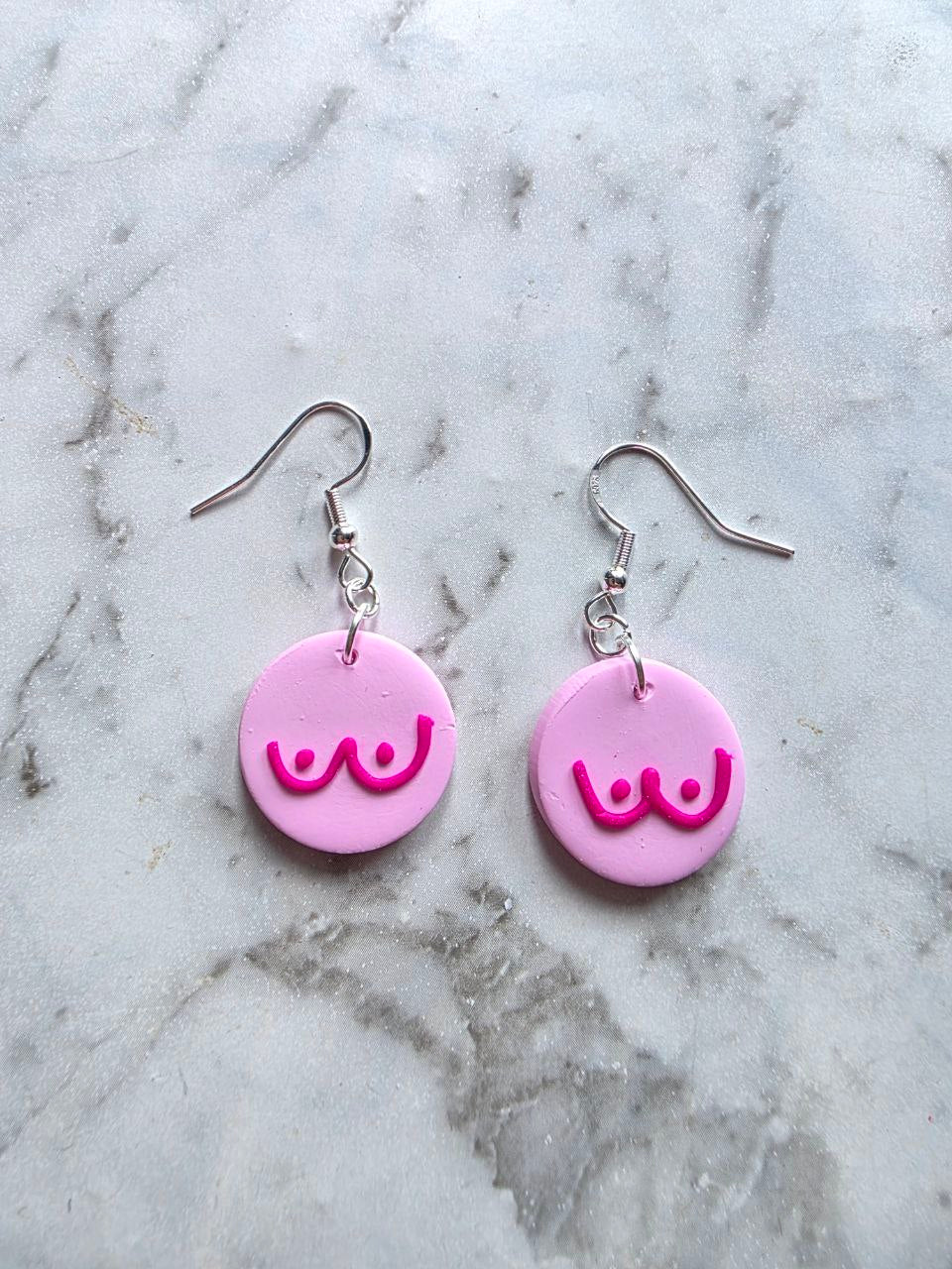 Handmade pink awareness earrings made from polymer clay with stainless hooks, supporting breast cancer awareness.