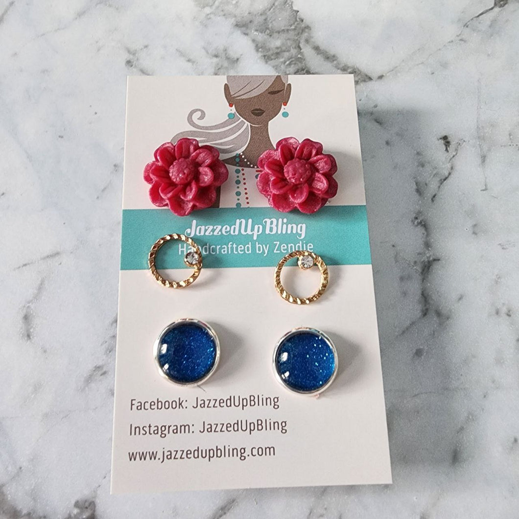 Red flower polymer clay studs paired with blue sparkle vinyl-wrapped round earrings from Jazzed Up Bling, handmade in New Zealand.