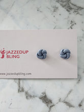 Load image into Gallery viewer, Soft pastel blue polymer clay knot studs with a smooth matte finish.
