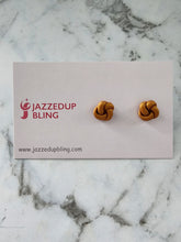 Load image into Gallery viewer, Warm golden clay knot earrings with a rich, handmade look.
