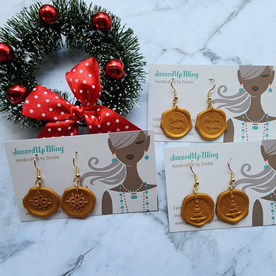 Handcrafted gold wax seal Christmas earrings with festive holiday designs by Jazzed Up Bling.
