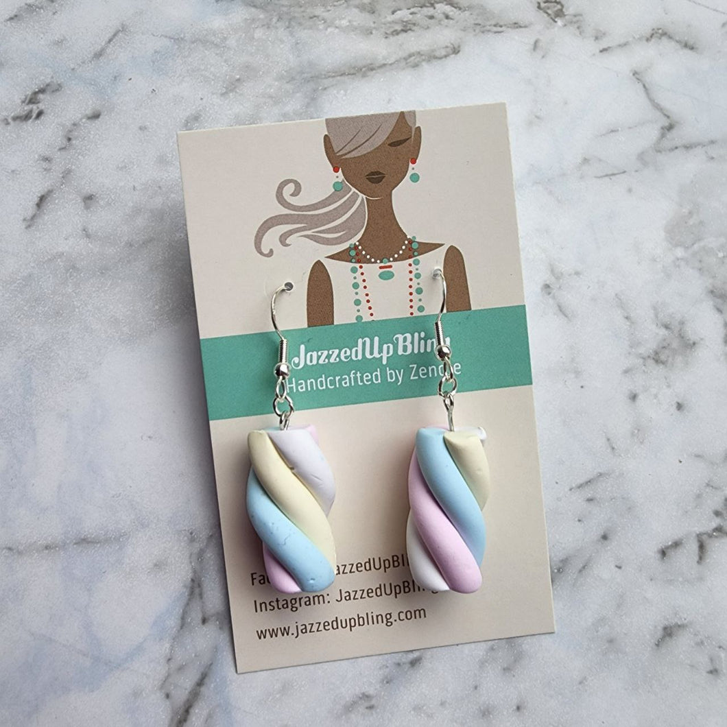 Polymer clay marshmallow earrings in soft pastel pink, blue, yellow, and white.
